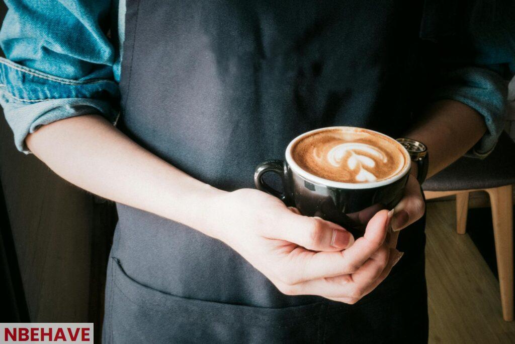 Woman Holding Mug of Cappuccino