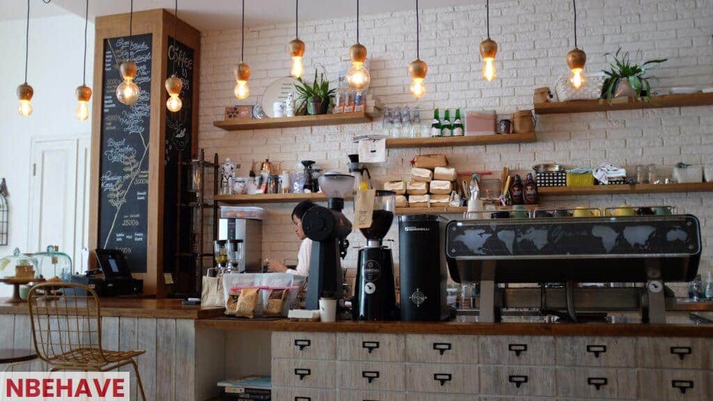 black kitchen appliance on kitchen island with pendant lights